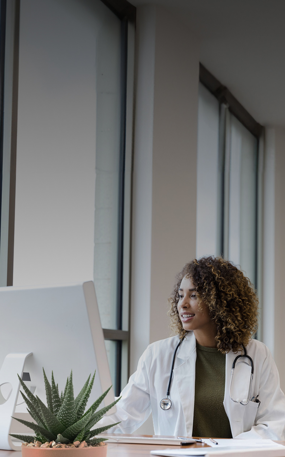 A veterinarian working at a computer in her clinic