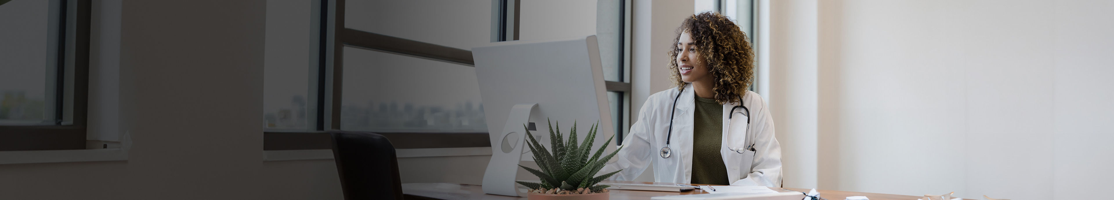 A veterinarian working at a computer in her clinic